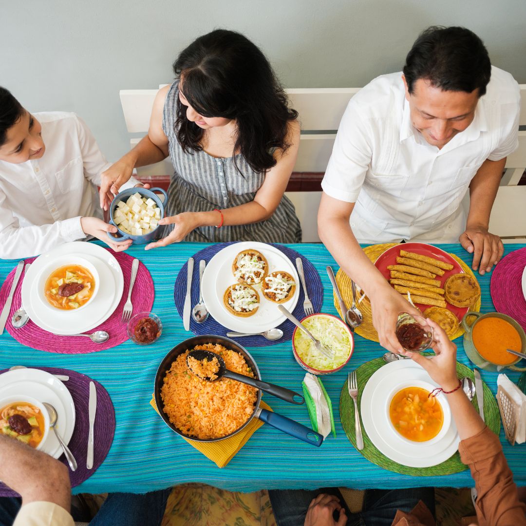 family with table food of flavorful mexican food